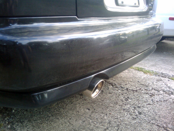 Close-up of a car's rear bumper and exhaust pipe