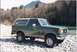 1990 Ford Bronco - This 1990 Ford Bronco is parked on a rocky riverbank with a wooded mountainside behind it.