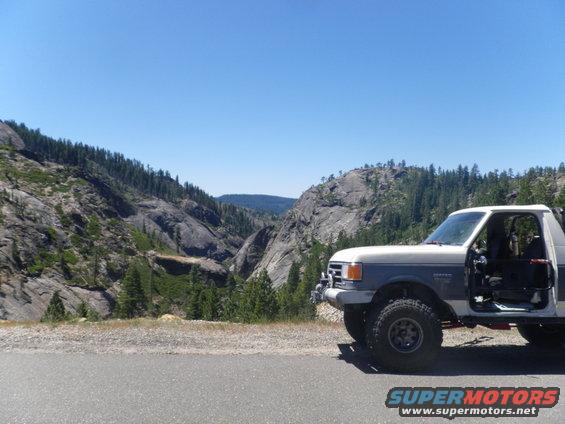 1991 Ford Bronco, 3q-front view, white and blue, parked roadside with mountain scenery