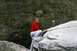 1990 Chevrolet Suburban - A woman in a red hoodie and grey pants ascends a rocky incline.