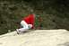 1990 Chevrolet Suburban - A person is shown in a crouched position, appearing to climb a large rock formation.