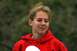 1990 Chevrolet Suburban - A young woman with freckles and messy blonde hair wears a red hooded sweatshirt outdoors.