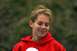 1990 Chevrolet Suburban - A young woman with her hair up smiles slightly while wearing a red hoodie.