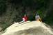 1990 Chevrolet Suburban - Two young women relax on a large boulder in a natural outdoor setting.