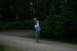 1990 Chevrolet Suburban - A person prepares to throw a football in a park setting with trees in the background.