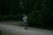 1990 Chevrolet Suburban - A person stands on a dirt path in a park, looking up at the trees.