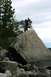 1990 Chevrolet Suburban - A couple takes a selfie while standing atop a large boulder near a wooded area.