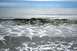 1990 Chevrolet Suburban - The ocean churns with waves and foam under a gray, cloudy sky.
