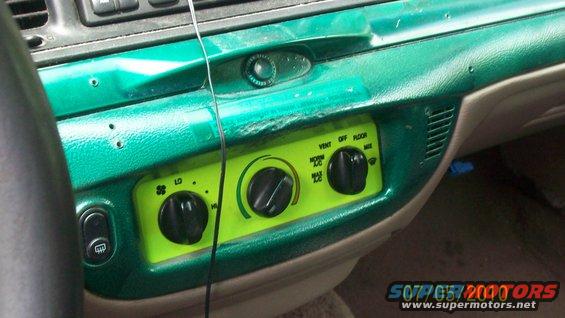 2004 Ford Crown Victoria interior dashboard with green painted trim and climate controls