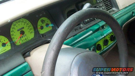 Dashboard of a 2004 Ford Crown Victoria with green accents and a speedometer showing 28526 miles