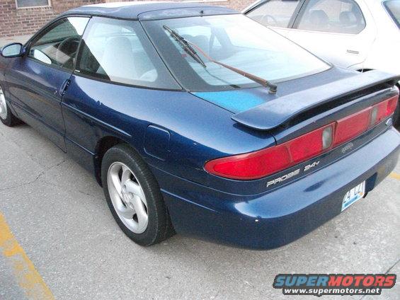 Blue 1994 Ford Probe coupe, rear 3/4 view, with a spoiler and a rear wiper