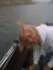 1992 Tracker Pro - A woman on a boat has a fishing lure stuck in her hair while she smiles.