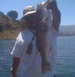1992 Tracker Pro - A person proudly displays a large fish caught on a sunny day near a body of water.