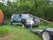 1989 Ford Bronco - A green Ford F-Series truck is parked in a grassy area with a boy walking on a trailer in front of it.