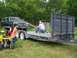 1989 Ford Bronco - A 1989 Ford Bronco is parked near a trailer being loaded, with a quad bike nearby.