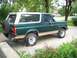 1989 Ford Bronco - Side view of a 1989 Ford Bronco parked on a driveway.