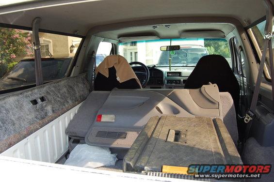 Interior of a 1992 Ford Bronco with disassembled parts in the cargo area