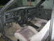 1985 Ford Mustang - The interior of a 1985 Ford Mustang is visible, a dashboard with gauges, a steering wheel, and cloth seats.