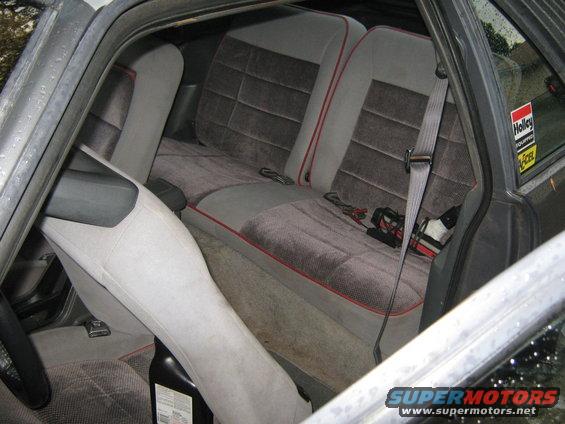 1985 Ford Mustang interior rear seats with gray velour and red piping