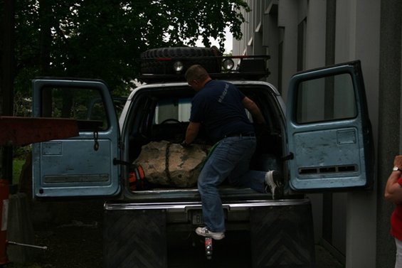 Light blue 1990 Chevrolet Suburban with rear doors open, man loading cargo