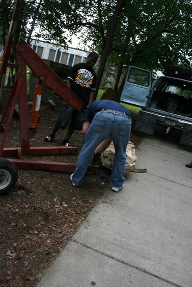 1990 Chevrolet Suburban, blue, with open door, rear view, parked on concrete next to dirt area