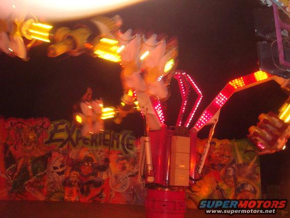 Blurry carnival ride with flashing lights and graffiti art background
