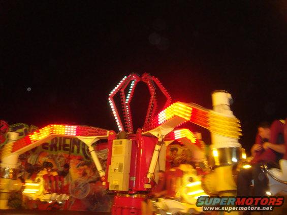 Carnival ride with red and yellow lights at night