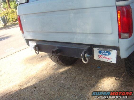 White Ford Bronco rear bumper with tow hooks, spare tire, and a Ford Racing license plate