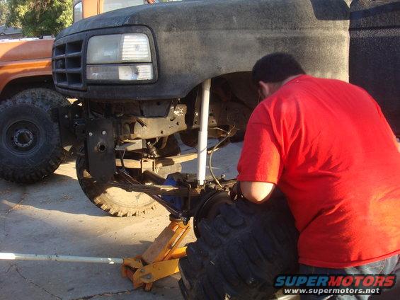 1992 Ford Bronco front end being worked on, another truck in background