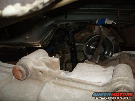 Close-up of vehicle transmission and drivetrain parts, with Supermotors.net logo visible