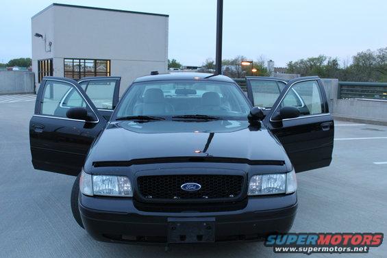 2007 Ford Crown Victoria, front view, all doors open, parked on a rooftop