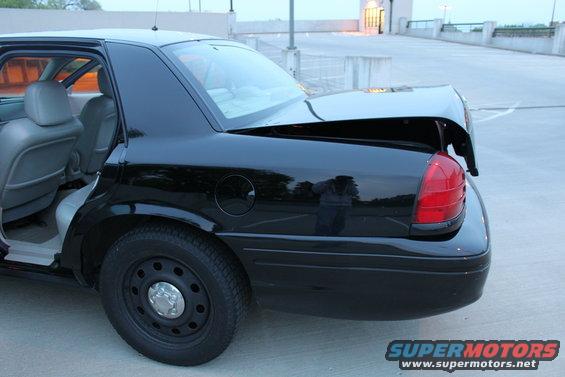 2007 Ford Crown Victoria rear quarter panel and open trunk, showing interior seats