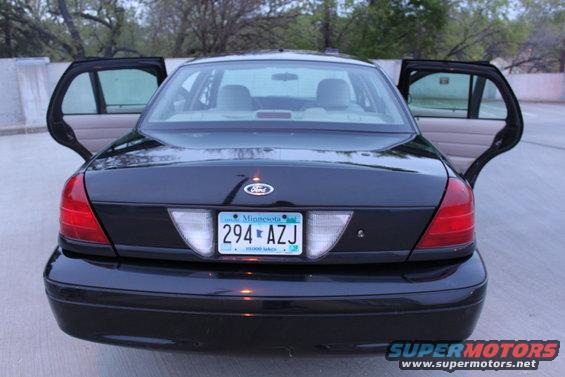 Black 2007 Ford Crown Victoria with rear doors open. Minnesota license plate 294 AZJ