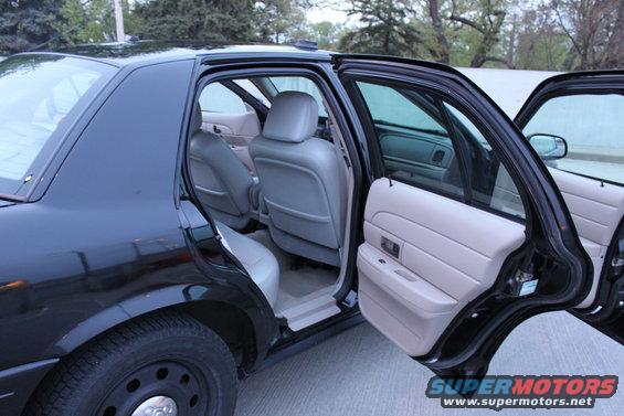 Black 2007 Ford Crown Victoria interior with doors open, showing front and rear seats