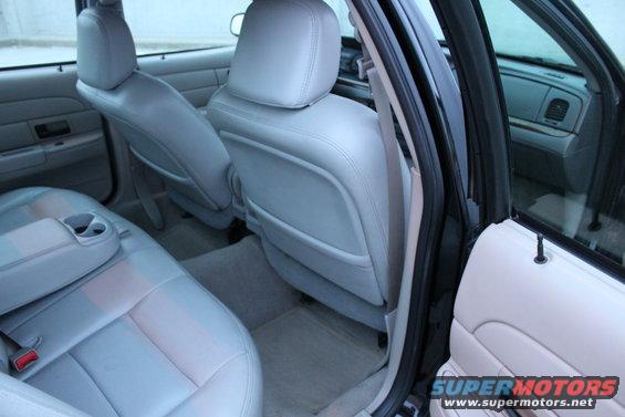 2007 Ford Crown Victoria interior showing front and rear seats, center console with cup holder, and door panel