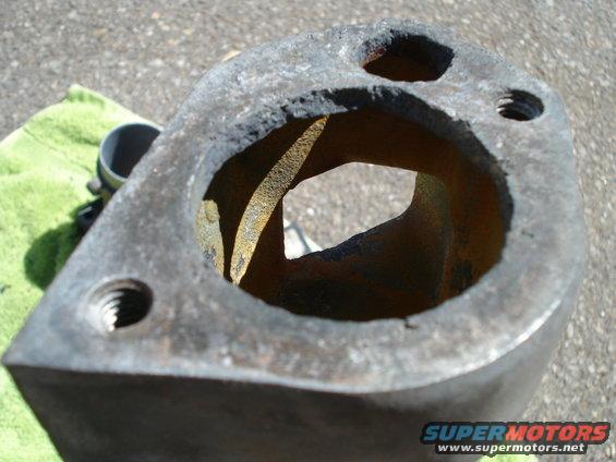 rusted metal engine part with threaded holes