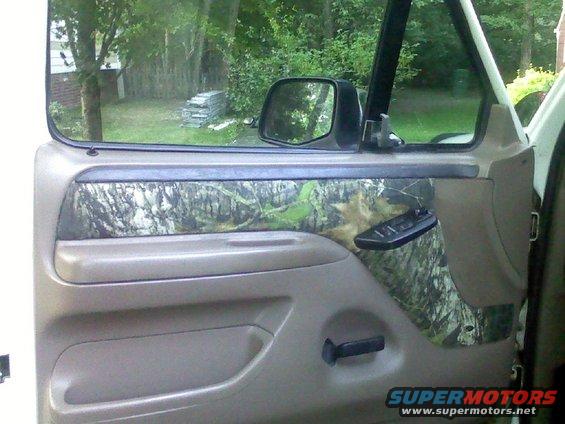 Interior door panel with camouflage trim and power window controls