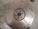 1990 Ford Mustang - A metal flywheel, likely from a vehicle's transmission, is shown from a top-down perspective.