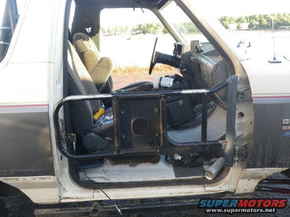 1991 Ford Bronco interior showing driver's seat, dashboard, and custom door bars