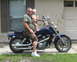 1995 Honda Shadow Sabre VT 1100 - Man and baby on a blue motorcycle outside a house.