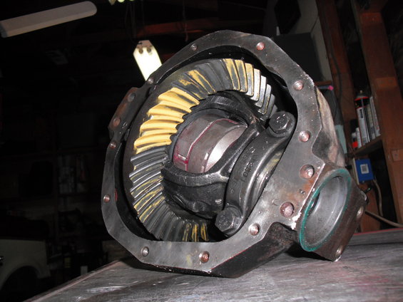 Close-up of a differential gear assembly with yellow and silver teeth