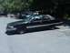 1991 Ford Crown Victoria LTD - This black sedan, identified as a Roadmaster, is parked in an outdoor lot with other vehicles present.
