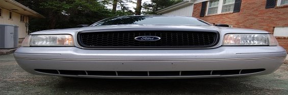 Silver 2003 Ford Crown Victoria front grille and headlights