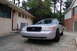 2003 Ford Crown Victoria - A silver 2003 Ford Crown Victoria is parked in a driveway, showing its front end.