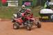 2004 Honda TRX 400 EX - ATV riders compete on a dusty track, with sponsors banners visible in the background.