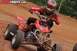 2004 Honda TRX 400 EX - A rider in full gear navigates a muddy dirt track on a red ATV, with prominent watermarks from ATVRiders.com and Supermotors.net.