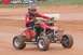 2004 Honda TRX 400 EX - A rider in full gear navigates a dirt track on a red 2004 Honda TRX 400 EX ATV.