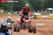 2004 Honda TRX 400 EX - Quad bikes compete on a dirt track during a race event.