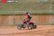 2004 Honda TRX 400 EX - A rider on a red ATV kicks up dust while navigating a dirt track.