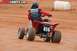 2004 Honda TRX 400 EX - A rider on a red ATV with the number 414 navigates a dirt track, viewed from the rear.
